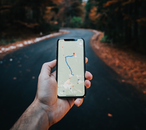Hand holding phone with uk map app open