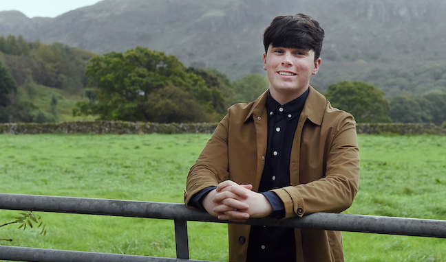 Young entrepreneur smiling in field